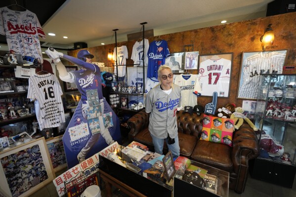 Hironobu Kanno, representative of a private fan club of Shohei Ohtani of the Los Angeles Dodgers, shows his collection items at his beauty salon in Oshu, northeastern Japan, the hometown of Ohtani, Tuesday, Oct. 29, 2024. (AP Photo/Eugene Hoshiko)