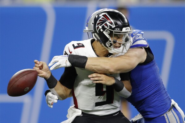 Atlanta Falcons quarterback Desmond Ridder (9) fumbles as he is sacked by Detroit Lions defensive end Aidan Hutchinson in the second half of an NFL football game Sunday, Sept. 24, 2023, in Detroit. Hutchinson recovered the ball on the play. (AP Photo/Al Goldis)