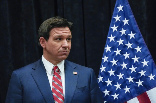 Republican presidential candidate Florida Gov. Ron DeSantis listens as Bob Vander Plaats speaks to media following a Fox News Town Hall in Des Moines, Iowa, Tuesday, Jan 9, 2024. (AP Photo/Carolyn Kaster)