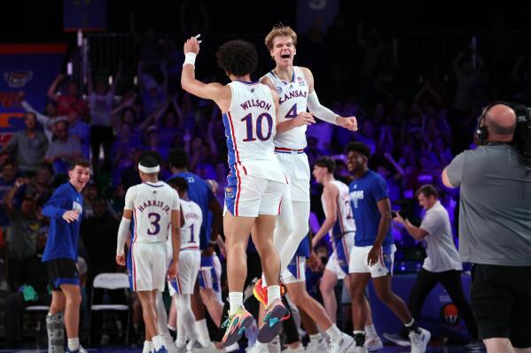 In a photo provided by Bahamas Visual Services, Kansas' Jalen Wilson (10) and Gradey Dick (4) celebrate during an NCAA college basketball game against Wisonsin in the Battle 4 Atlantis at Paradise Island, Bahamas, Thursday, Nov. 24, 2022. (Tim Aylen/Bahamas Visual Services via AP)