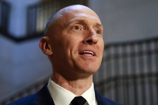 FILE - In this Nov. 2, 2017, photo, Carter Page, a foreign policy adviser to Donald Trump's 2016 presidential campaign, speaks with reporters following a day of questions from the House Intelligence Committee, on Capitol Hill in Washington.  Page, who was the target of a secret surveillance warrant during the FBI’s Russia investigation says in a federal lawsuit filed Friday, Nov. 27, 2020,  that he was the victim of “unlawful spying.” The suit from Carter Page alleges a series of omissions and errors made by FBI and Justice Department officials in applications they submitted to the Foreign Intelligence Surveillance Court to eavesdrop on Page on suspicion that he was an agent of Russia.(AP Photo/J. Scott Applewhite)