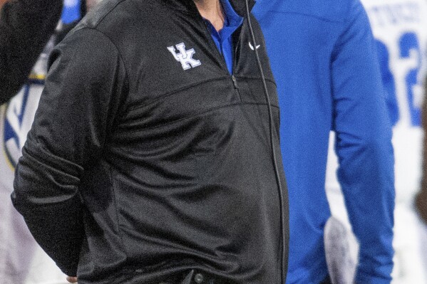 Kentucky coach Mark Stoops stands on the sideline during the first half of the team's NCAA college football game against Georgia, Saturday, Oct. 7, 2023, in Athens, Ga. (AP Photo/Hakim Wright Sr.)