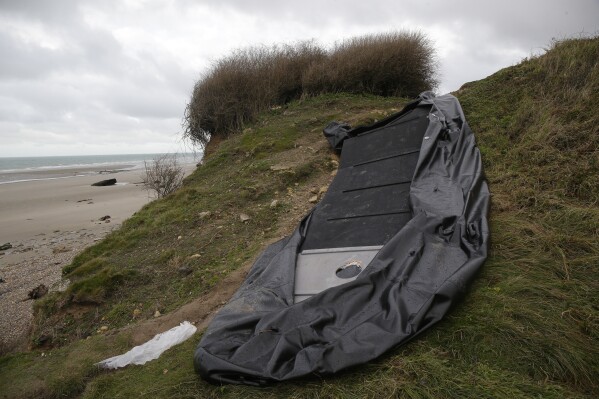 FILE - A damaged inflatable small boat is pictured on the shore in Wimereux, northern France, Thursday, Nov. 25, 2021 near Calais, northern France. A French report published Thursday Jan.4, 2024 said the UK is not sufficiently coordinating with France in efforts to reduce numbers of migrants crossing the English Channel in small boats, as part of a broader assessment pointing to the 