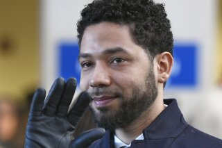 FILE - In this March 26, 2019, file photo, actor Jussie Smollett smiles and waves to supporters before leaving Cook County Court after his charges were dropped in Chicago. An Illinois judge seems close to appointing a special prosecutor to look into why state prosecutors abruptly dropped charges against Smollett accusing him of staging a racist, anti-gay attack against himself. A hearing Friday, Aug. 23 will be one of the first opportunities for Judge Michael Toomin to name someone since his surprise ruling in June that a special prosecutor was warranted. Among the options available to a special prosecutor would be to restore charges against Smollett.  (AP Photo/Paul Beaty, File)