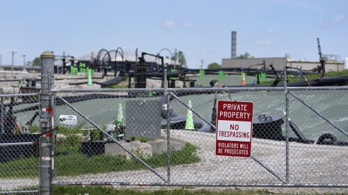 A no trespassing sign hangs on a fence around the West Lake Landfill Superfund site on Friday, April 21, 2023, in Bridgeton, Mo. Federal officials plan to remove some of the hazardous leached barium sulfate that is at the landfill and cap the rest. (AP Photo/Jeff Roberson)
