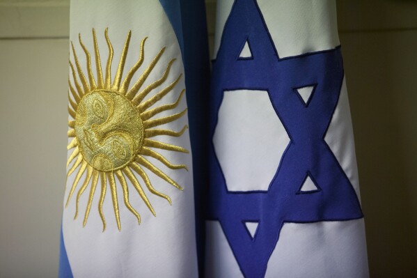 FILE - An Argentine and Israeli flag stand side by side at the office of Guillermo Borger, president of the Jewish community center AMIA, during an interview with The Associated Press in Buenos Aires, Argentina, on Feb. 8, 2013. Argentina’s highest criminal court on Thursday, April 12, 2024, reported a new development in the elusive quest for justice in the country’s deadliest attack in history – the 1994 bombing of a Jewish community center headquarters – concluding Iran had planned the attack and Lebanon’s Hezbollah militant group had executed the plans. (AP Photo/Victor R. Caivano)