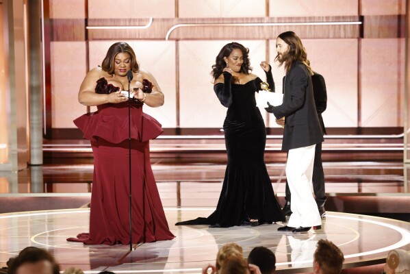 This image released by CBS shows host Da'Vine Joy Randolph, left, accepting the award for best female supporting actor in a motion picture for her role in "The Holdovers" during the 81st Annual Golden Globe Awards in Beverly Hills, Calif., on Sunday, Jan. 7, 2024. At right are presenters Angela Basset and Jared Leto. (Sonja Flemming/CBS via AP)