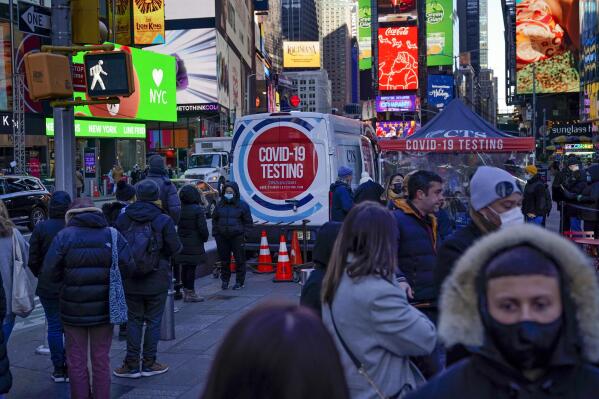 People wait in a long line to get tested for COVID-19 in Times Square, New York, Monday, Dec. 20, 2021. Just a couple of weeks ago, New York City seemed like a relative bright spot in the U.S. coronavirus struggle. Now it's a hot spot, confronting a dizzying spike in cases, a scramble for testing, a quandary over a major event and an exhausting sense of déjà vu. (AP Photo/Seth Wenig)