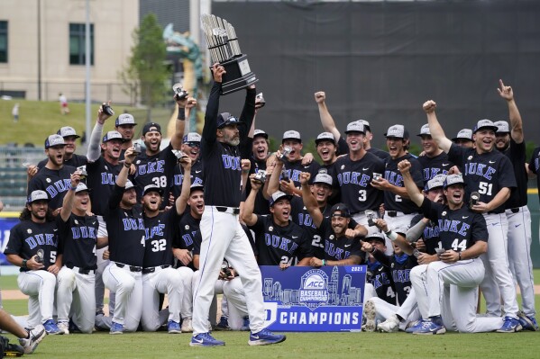 FILE - Duke coach Chris Pollard holds the trophy after a win overt North Carolina State in an NCAA college baseball game during the Atlantic Coast Conference championship game on Sunday, May 30, 2021, in Charlotte, N.C. Duke moved into the top 10 of the national rankings Monday, March 11, 2024, after winning two of three on the road against Wake Forest, which had opened the season No. 1 in the major polls. (AP Photo/Chris Carlson, File)