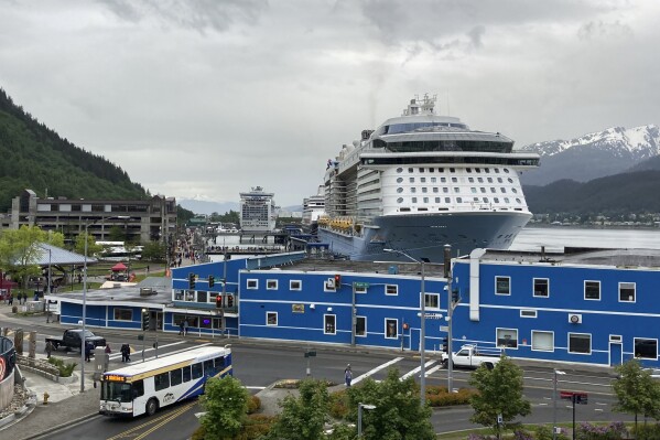 FILE - Cruise ships are docked on June 9, 2023, in downtown Juneau, Alaska. A new agreement between Alaska's capital city and major cruise lines seeks to cap the daily number of cruise ship passengers arriving in Juneau starting in 2026, but a critic of the cruise industry says the planned limits don't go far enough. (AP Photo/Becky Bohrer, File)
