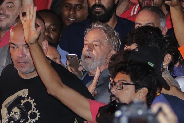 
              Former President Luiz Inacio Lula da Silva, leaves the metal workers union headquarters in Sao Bernardo do Campo, Brazil, Saturday, April 7, 2018. Da Silva was taken into police custody later Saturday after a tense showdown with his own supporters, the capstone of an intense three days that underscored raw emotions over the incarceration of a once wildly popular leader who has been engulfed by corruption allegations. (AP Photo/Thiago Bernardes/FramePhoto)
            