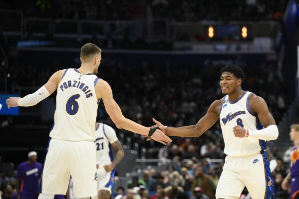 Washington Wizards forward Rui Hachimura (8) celebrates with center Kristaps Porzingis (6) after Hachimura scored during the first half of the team's NBA basketball game against the Phoenix Suns, Wednesday, Dec. 28, 2022, in Washington. (AP Photo/Nick Wass)