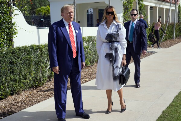 Republican presidential candidate former President Donald Trump and former first lady Melania Trump pauses to speak after voting in the Florida primary election in Palm Beach, Fla., Tuesday, March 19, 2024. (AP Photo/Wilfredo Lee)