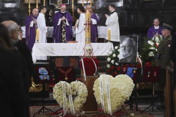 The urn with ashes and a photo of Poland's award-winning composer and conductor Krzysztof Penderecki during his much-delayed burial service at St. Peter and Paul Church in Krakow, Poland, on Tuesday, March 29, 2022. Penderecki died in March 2020, at 86, but his state funeral was delayed by two years by the global COVID-19 pandemic. (AP Photo)