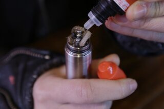 
              FILE - In this Feb. 20, 2014 file photo, a liquid nicotine solution is poured into a vaping device at a store in New York. According to a study released on Wednesday, Jan. 30, 2019, twice as many people successfully quit smoking using electronic cigarettes than older nicotine gums and patches, providing the strongest evidence yet that vaping can help smokers break their addiction to cigarettes. (AP Photo/Frank Franklin II)
            