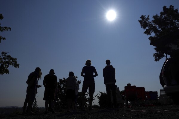 FILE - People gather near Redmond, Ore., to view the sun as it nears a total eclipse by the moon, Monday, Aug. 21, 2017. The April 8, 2024 total solar eclipse in North America first hits land at Mexico鈥檚 Pacific coast, cuts diagonally across the U.S. from Texas to Maine and exits in eastern Canada. (APPhoto/Ted S. Warren, File)