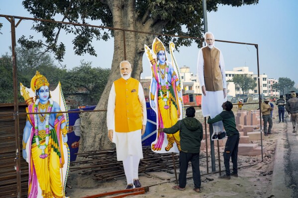 FILE - Workers put up cutouts of Hindu deity Lord Ram and Indian Prime Minister Narendra Modi to mark the opening of a grand temple for Lord Ram in Ayodhya, India, Thursday, Jan. 18, 2024. Coming ahead of the upcoming national elections, the ceremony has welded into a potent mix of religion and statecraft that analysts say will secure an enduring, though contentious legacy for Modi who is seeking a third-consecutive term. (AP Photo/Deepak Sharma, File)
