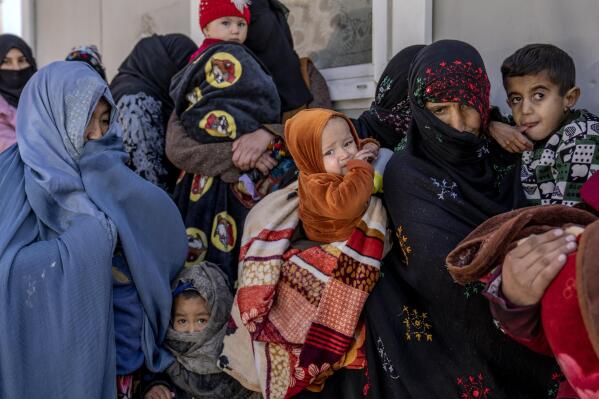 Mothers along with babies who suffer from malnutrition wait to receive help and check-up at a clinic that run by the WFP, in Kabul, Afghanistan, Thursday, Jan. 26, 2023. A spokesman for the U.N. food agency says malnutrition rates in Afghanistan are at record highs. Aid agencies have been providing food, education, healthcare and other critical support to people, but distribution has been severely impacted by a Taliban edict banning women from working at national and international nongovernmental groups. (AP Photo/Ebrahim Noroozi)