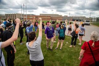 Protestors chant "Let them go" as Des Moines police vans arrive at the Polk County Jail after protestors were arrested outside the Capitol, in Des Moines, Iowa, on Wednesday, July 1, 2020. Two central Iowa police officers are suing a sitting Des Moines City Council member and five other people who participated in a racial justice protest in 2020, and are seeking an unspecified amount in damages in what experts say is a legal move rarely taken by police and other first responders. (Zach Boyden-Holmes/The Des Moines Register via AP)