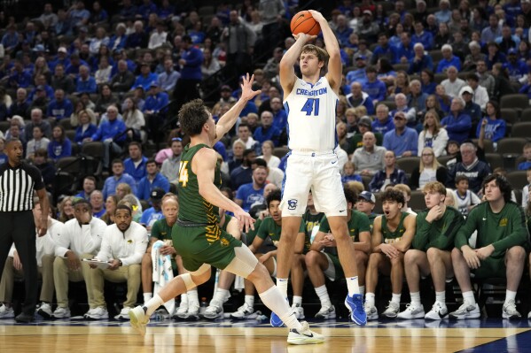 FILE - Creighton forward Isaac Traudt (41) shoots a 3-point basket over North Dakota State guard Boden Skunberg (14) during the first half of an NCAA college basketball game, Saturday, Nov. 11, 2023, in Omaha, Neb. Creighton's Isaac Traudt is playing at the highest level of college basketball while managing Type 1 diabetes.(AP Photo/Charlie Neibergall, File)