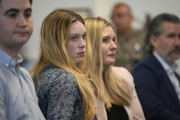 Taylor Edwards, left, and Kaitlyn Kash, who are plaintiffs in Zurawski v Texas, listen at the Texas Medical Board meeting to discuss guidance around physicians for medical exceptions to the state's abortion ban laws at the George H.W. Bush State Office Building in Austin, Texas, Friday March 22, 2024. (Jay Janner /Austin American-Statesman via AP)