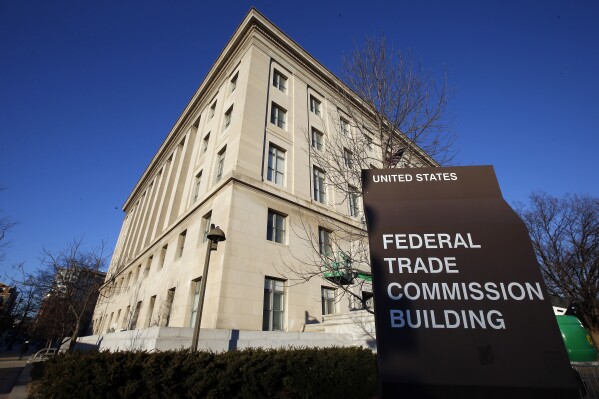 FILE - A sign stands outside the Federal Trade Commission building, Jan. 28, 2015, in Washington. On Wednesday, Nov. 15, 2023, the FTC said it issued warnings to two food and beverage industry groups, as well as a dozen online influencers and dietitians for failing to adequately disclose paid social media posts that promoted a sweetener and sugary products. (AP Photo/Alex Brandon, File)