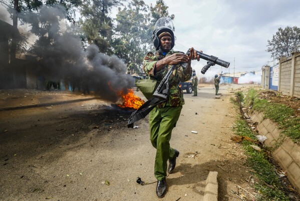 A riot policeman reloads a teargas grenade launcher during clashes with protesters in the Kibera area of Nairobi, Kenya July 19, 2023. The United States is praising Kenya's interest in leading a multinational force in Haiti. But weeks ago, the U.S. openly warned Kenyan police officers against violent abuses. Now 1,000 of those police officers might head to Haiti to take on gang warfare. (AP Photo/Brian Inganga,)