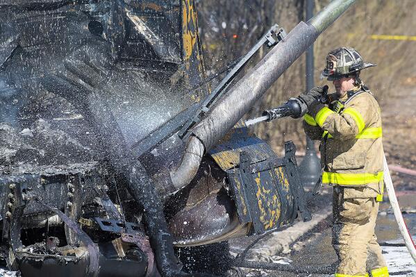 Firefighers work the scene after a tanker truck overturned on U.S. 15 in Frederick, Md., on Saturday, March 4, 2023. The fiery crash killed the driver and burned vehicles and homes in Frederick, about an hour's drive west of Baltimore, authorities said. (Bill Green /The Frederick News-Post via AP)