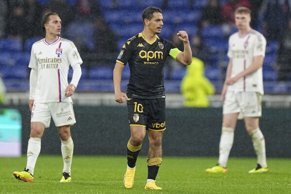 Monaco's Wissam Ben Yedder celebrates scoring his side's second goal during a French League One soccer match between Lyon and Monaco at the Groupama stadium in Decines, outside Lyon, France, Sunday, April 28, 2024. (AP Photo/Laurent Cipriani)