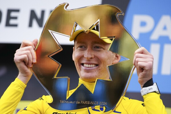Matteo Jorgenson of The United States celebrates on the podium after winning the general classification of Paris-Nice cycling race in Nice, Sunday, March 10, 2024. (AP Photo/Daniel Cole)
