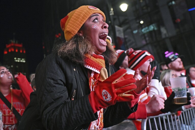 Kansas City Chiefs fan Porschae Oglesby reacts after a play during a Super Bowl 58 watch party at the Power and Light District, Sunday, Feb. 11, 2024, in Kansas City, Mo. (AP Photo/Peter Aiken)