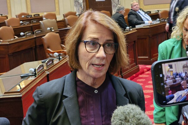 Minnesota Senate Democratic Majority Leader Erin Murphy talks with reporters on the Senate floor in the Minnesota State Capitol after a Republican attempt to expedite an ethics investigation of Democratic Sen. Nicole Mitchell, who's facing a felony burglary charge, failed on a tie vote, Wednesday, April 24, 2024 in St. Paul, Minn. (AP Photo/Steve Karnowski)