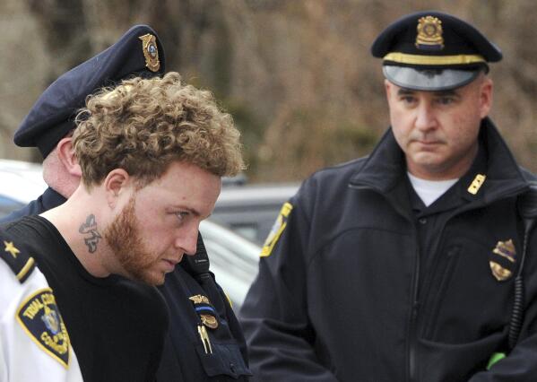 FILE — Thomas Latanowich, left, is brought into Barnstable District Court in this Friday, April 13, 2018 file photo, for his arraignment in Barnstable, Mass. The trial for Latanowich, who is charged with killing a Massachusetts police officer in 2018, is scheduled to get underway Monday, Aug. 2, 2021 with jury selection. (Steve Heaslip /The Cape Cod Times via AP, File)