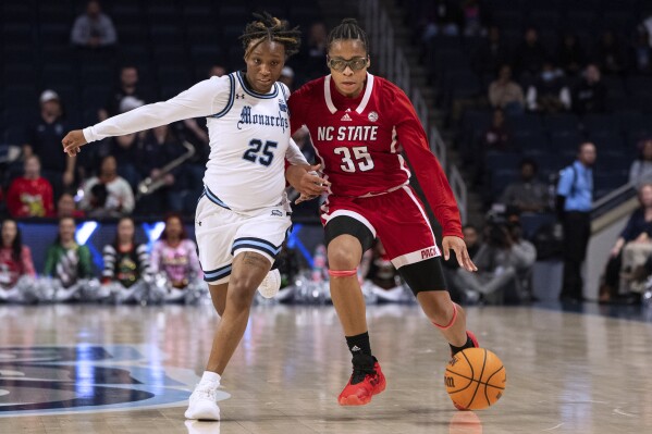 North Carolina State guard Zoe Brooks (35) drives against Old Dominion guard En'Dya Buford (25) during the first half of an NCAA college basketball game Wednesday, Dec. 20, 2023, in Norfolk, Va. (AP Photo/Mike Caudill)