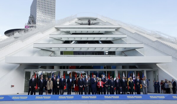 Leaders from EU and Western Balkans countries stand for a family photo in front of Pyramid Hall after Berlin Process Leaders' Summit in Tirana, Albania, Monday, Oct. 16, 2023. Leaders from the European Union and the Western Balkans hold a summit in Albania's capital to discuss the path to membership in the bloc for the six countries of the region. (AP Photo/Franc Zhurda)