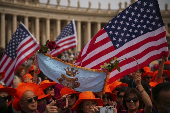 Faithful wave flags from the United States as they wait for Pope Leo XIV to appear at the central balcony of St. Peter's Basilica for his first Sunday blessing after his election, in St. Peter's Square at the Vatican, Sunday, May 11, 2025.(AP Photo/Andrew Medichini)