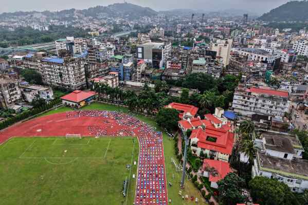 Indians perform yoga during an event to mark International Day of Yoga at a playground in Guwahati, India, Saturday, June 21, 2025. (AP Photo/Anupam Nath)