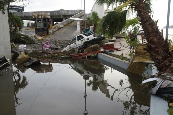 FILE - A street is strewn with debris after Hurricane Otis ripped through Acapulco, Mexico, Wednesday, Oct. 25, 2023. Hurricane Otis turned from mild to monster in record time, and scientists are struggling to figure out how — and why they didn't see it coming. (AP Photo/Marco Ugarte, File)