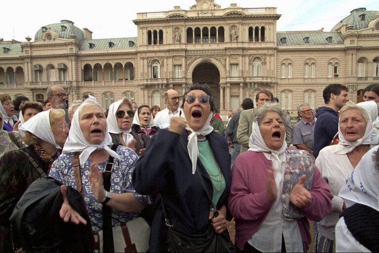 FILE - Mothers of Plaza de Mayo protest the disappearances of their children outside the Casa Rosada presidential office in Buenos Aires, Argentina April 27, 1995. The Mothers of Plaza de Mayo is a human rights organization created by women whose children were kidnapped by the military dictatorship that ruled Argentina from 1976 to 1983. (AP Photo/Eduardo Di Baia, File)