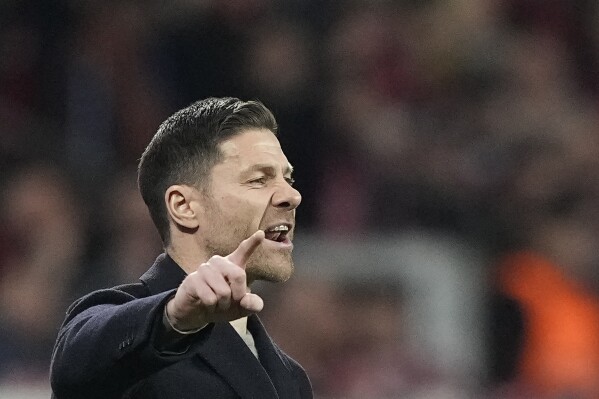 Leverkusen's head coach Xabi Alonso gestures during the German Bundesliga soccer match between Bayer Leverkusen and VfL Wolfsburg at the BayArena in Leverkusen, Germany, Sunday, March 10, 2024. (AP Photo/Martin Meissner)