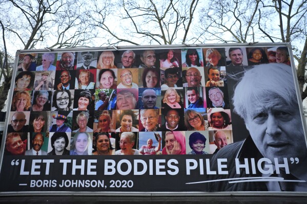 A van displaying a protest banner is parked outside the Covid-19 Inquiry in London, Wednesday, Dec. 6, 2023. Britain's former Prime Minister Boris Johnson will give evidence later. (APPhoto/Kirsty Wigglesworth)