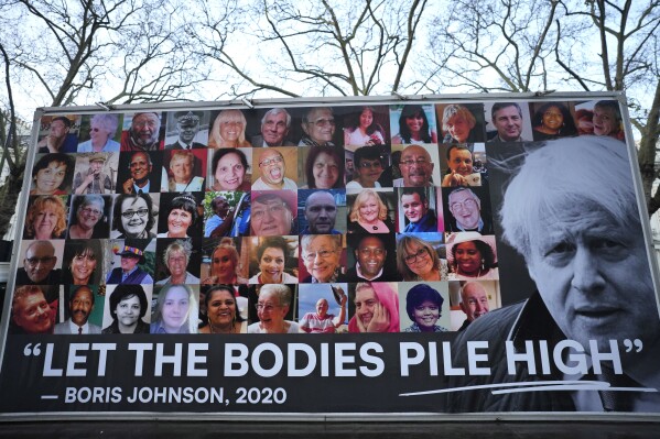 A van displaying a protest banner is parked outside the Covid-19 Inquiry in London, Wednesday, Dec. 6, 2023. Britain's former Prime Minister Boris Johnson will give evidence later. (AP Photo/Kirsty Wigglesworth)