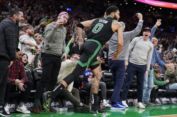 Fans celebrate after a 3-point basket by Boston Celtics forward Jayson Tatum (0) during the second half of an NBA basketball game against the New York Knicks, Monday, Nov. 13, 2023, in Boston. (AP Photo/Charles Krupa)