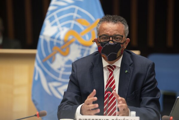 In this photo released by WHO, World Health Organisation on Monday, Oct. 5, 2020,  WHO Director-General, Dr Tedros Adhanom Ghebreyesus, wearing a mask to protect against coronavirus, gestures during a special session on the COVID-19 respnse. The head of emergencies at the World Health Organization says its “best estimates” indicate that roughly 1 in 10 people worldwide may have been infected by the coronavirus.  (Christopher Black/WHO via AP)