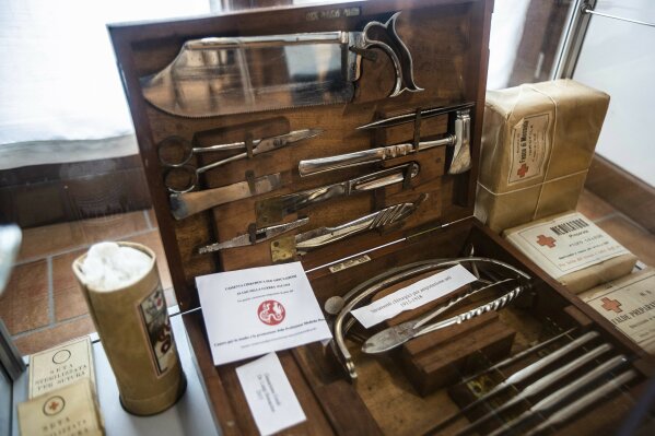 In this photo taken on Monday, April 25, 2020, surgical instruments for amputation used during World War II are displayed the center for the study of medical profession, at the Temple of Duno, in Duno, Northern Italy. Every October, on the feast day of the patron saint of physicians, Dr. Roberto Stella would organize a simple ceremony at a tiny church in northern Italy to honor Italian doctors who had died that year in the line of service. A doctor and teacher who trained a generation of family practitioners in Lombardy, Stella now occupies a place of tragic distinction in the pandemic in Italy: the first name on the list of more than 150 MDs who died in the COVID-19 crisis. (AP Photo/Luca Bruno)