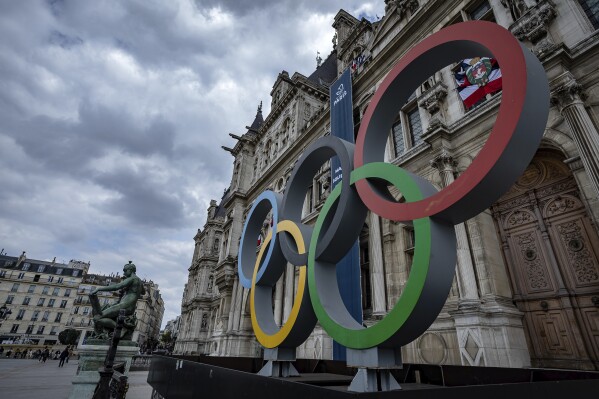 FILE - The Olympic rings are seen in front of the Paris City Hall, in Paris, on April 30, 2023. Paris City Hall said Wednesday Feb. 28, 2024 that no policing plans for the upcoming Olympic Games were lost in the theft of computer gear reported by one of its employees. (AP Photo/Aurelien Morissard, File)