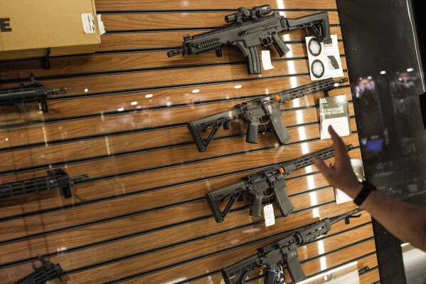 FILE - Shooting club owner Charles Blagitz shows machine guns at his shooting club in Sao Paulo, Brazil, Oct. 25, 2022. Brazil’s President Luiz Inácio Lula da Silva signed a decree July 21, 2023 tightening restrictions on civilian access to guns in Brazil. (AP Photo/Matias Delacroix, File)