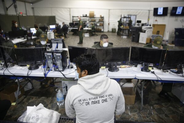 A migrant is processed at the intake area of the U.S. Customs and Border Protection facility, the main detention center for unaccompanied children in the Rio Grande Valley, in Donna, Texas, Tuesday, March 30, 2021. (AP Photo/Dario Lopez-Mills,Pool)