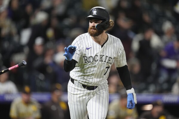 Colorado Rockies' Brendan Rodgers tosses his bat after hitting a grand slam off San Diego Padres starting pitcher Michael King during the fourth inning of a baseball game Tuesday, April 23, 2024, in Denver. (AP Photo/David Zalubowski)