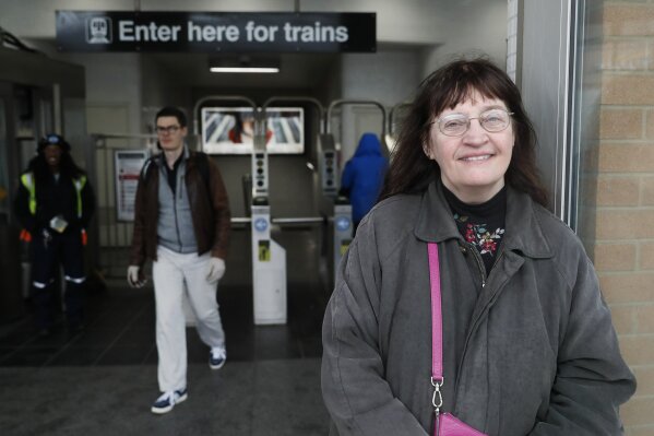 Playwright Vicki Quade poses for a portrait at the North & Clybourn Streets "L" station Monday, March 9, 2020, in Chicago. Older adults, those 60 and up like Quade should avoid crowds, cruises and long plane trips to avoid the coronavirus, advice that one public health official acknowledged won't be welcomed by many. Quade, 66, said she thinks most of the advice is extreme. "Yes, be a bit more cautious, wash your hands and if you're not feeling good, stay inside," "I'm not that worried. Perhaps I should be but I think we have to continue just living our lives," Quade said. (AP Photo/Charles Rex Arbogast)
